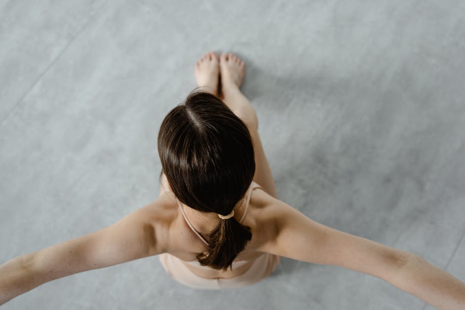 Professional dance instructor demonstrating elegant movement in a modern dance studio
